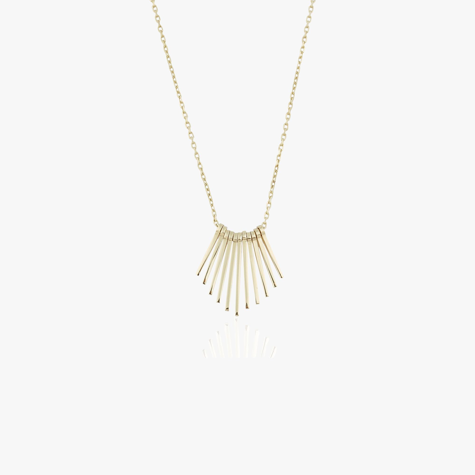 A 14k yellow gold necklace with several spikes create the illusion of a sunrise shown on a white background.