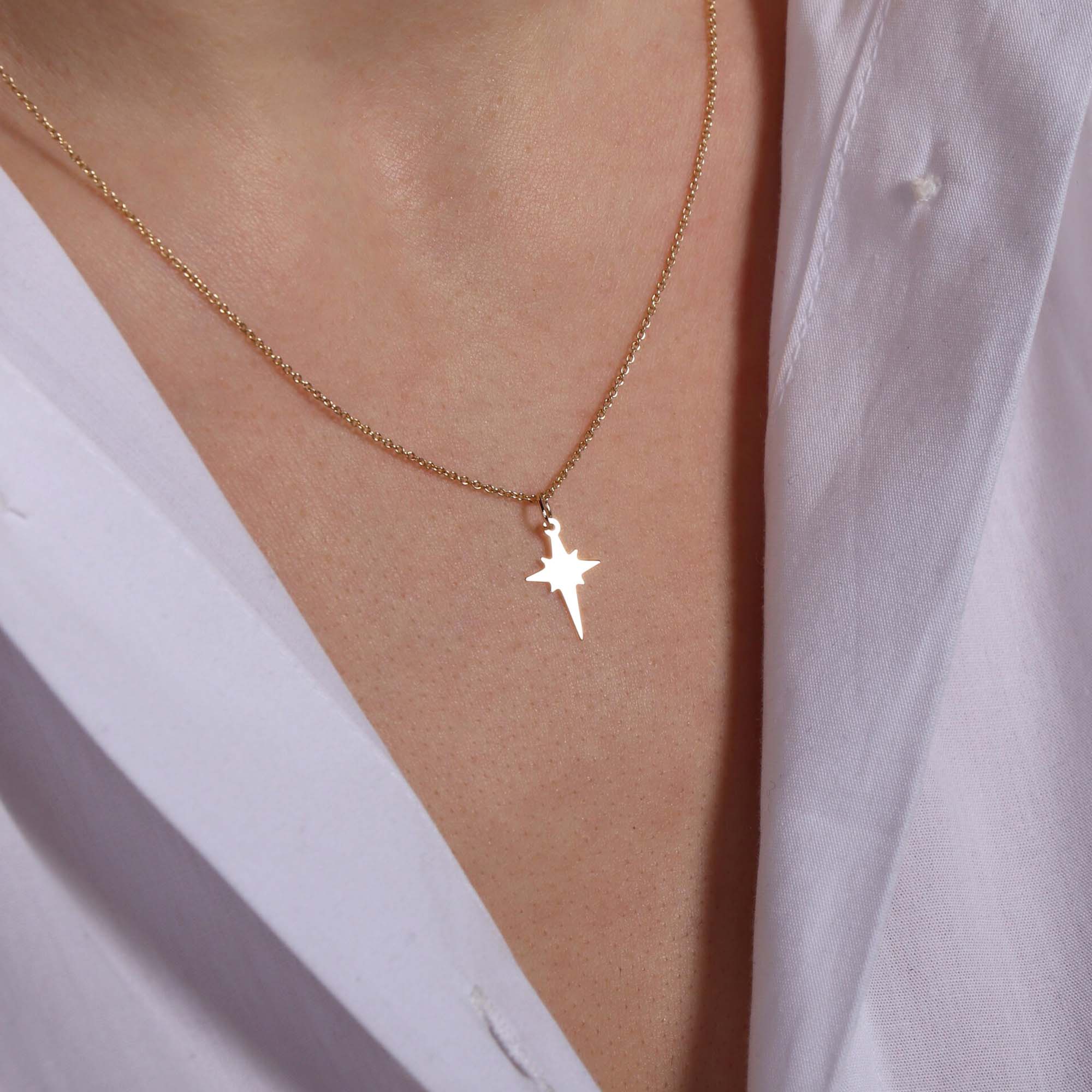 A model wearing a tiny north star necklace 