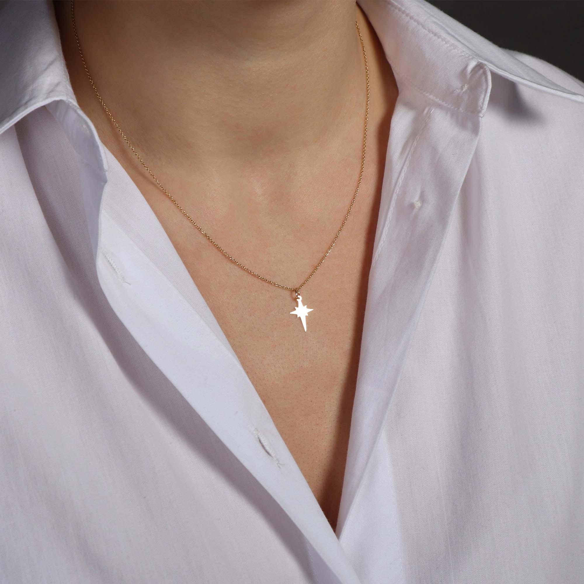 A model wearing a tiny north star necklace 