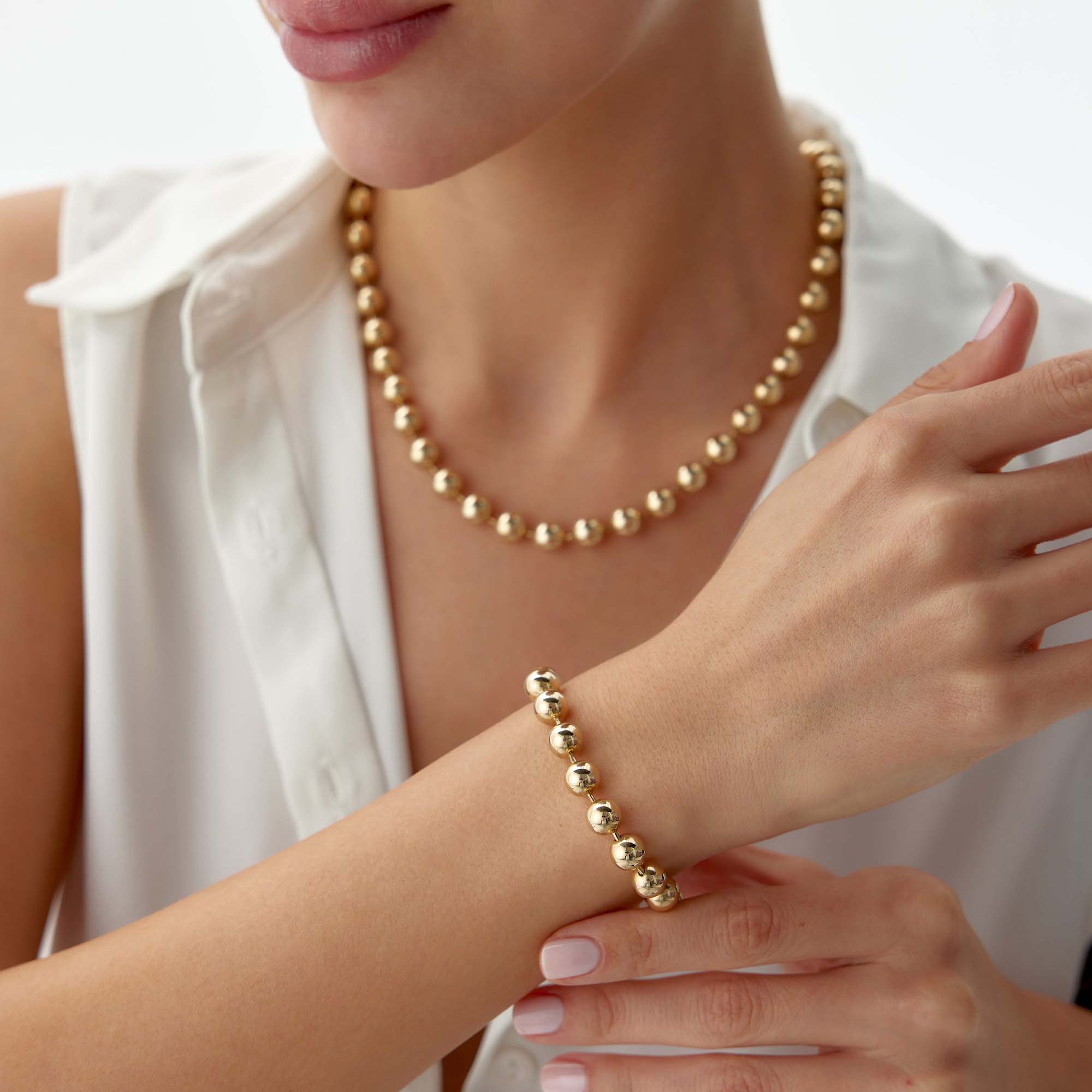 14k yellow gold large beaded bracelet shown in a wrist