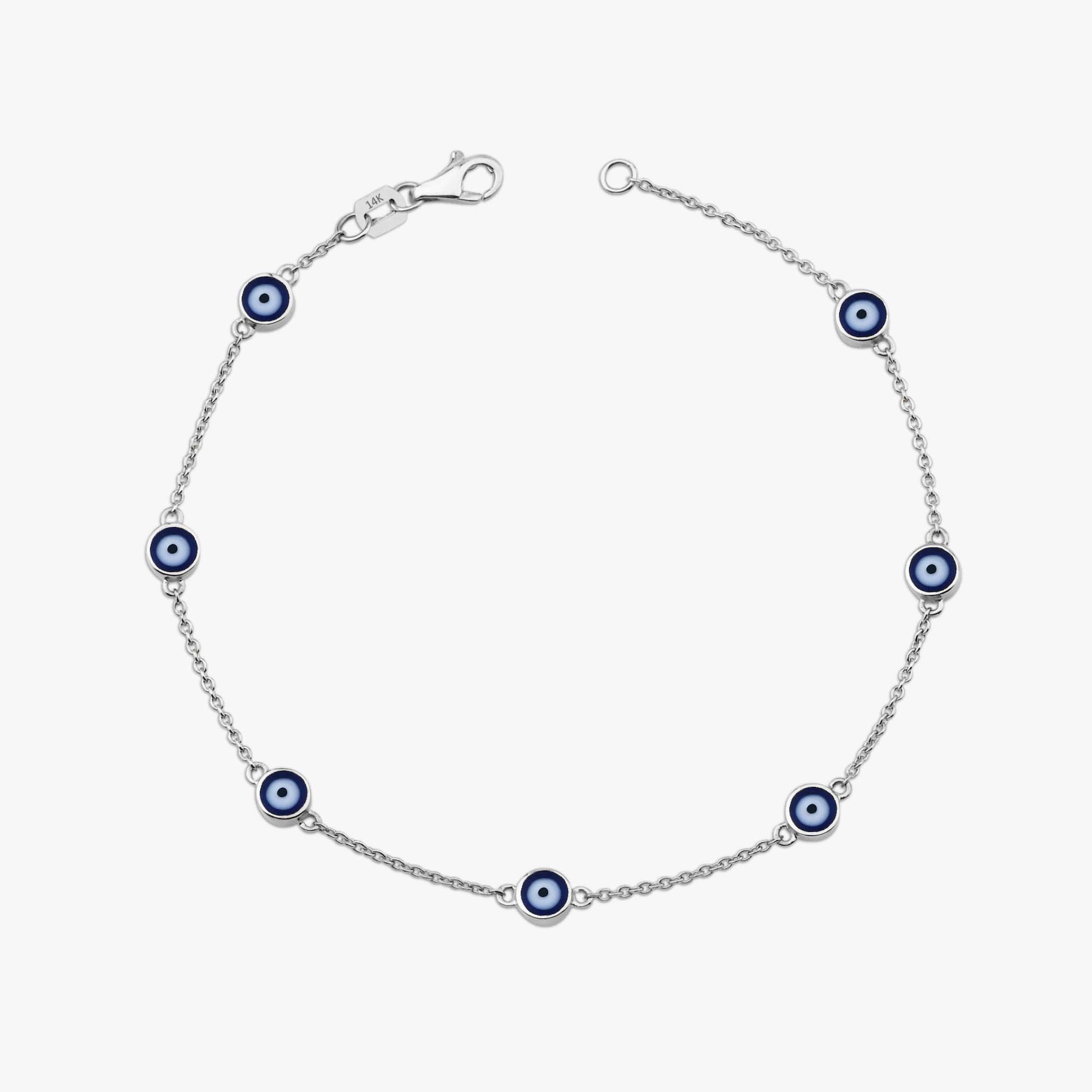 14k white gold navy blue evil eye bracelet with 7 evil eyes shown on a white background