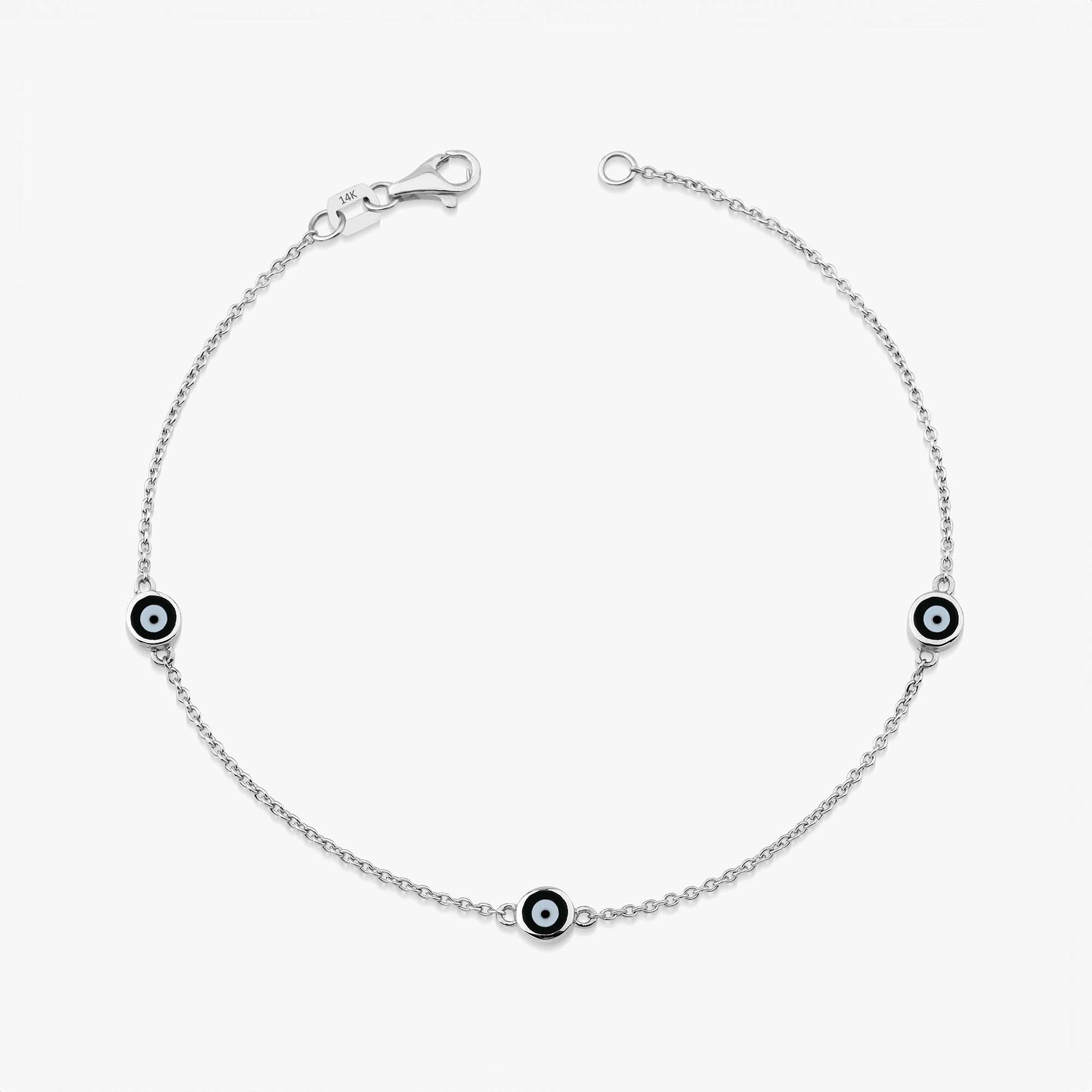 14 karat yellow gold three black evil eye bracelet with lobster clasp on a white background