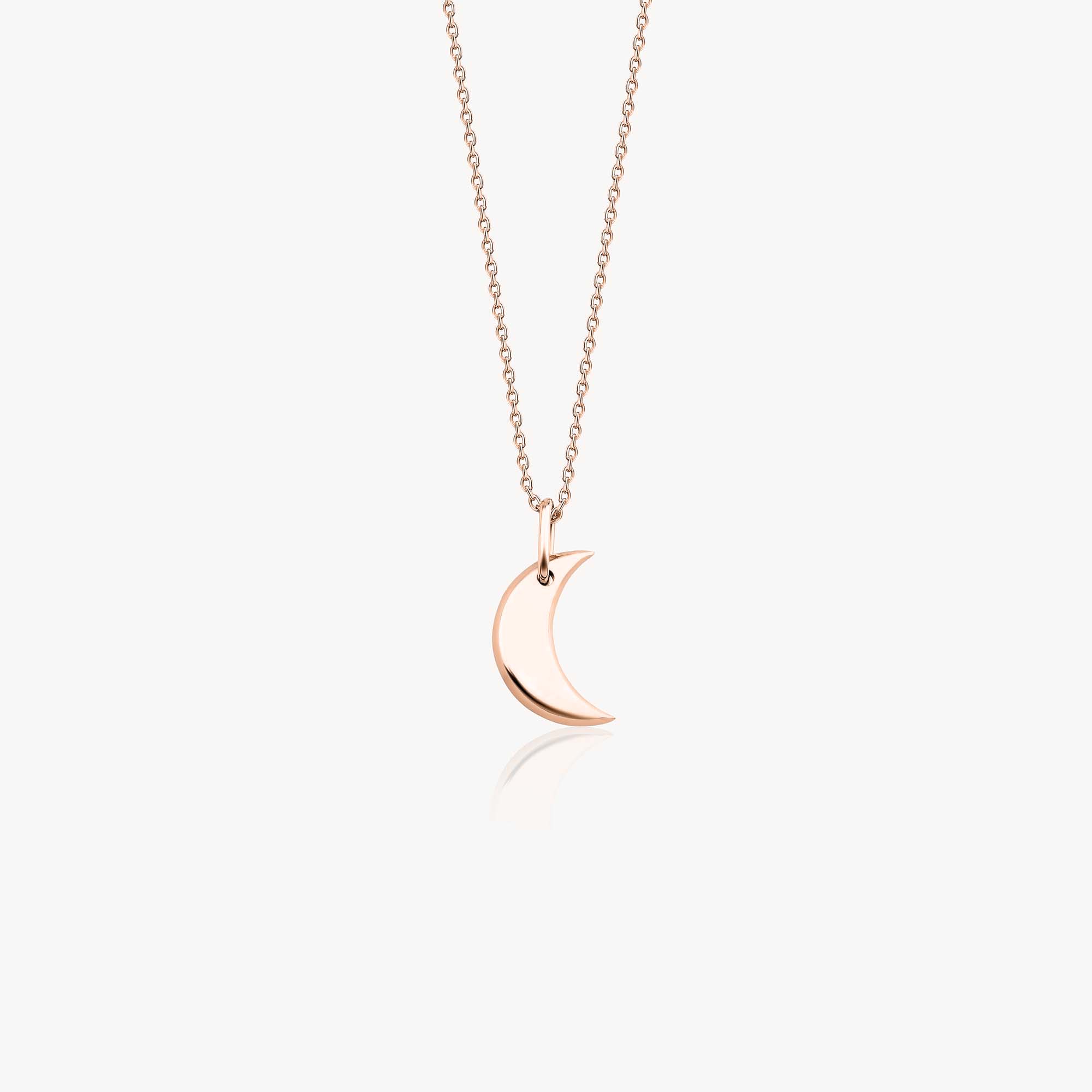 A minimal 14k rose gold crescent moon necklace on a white background