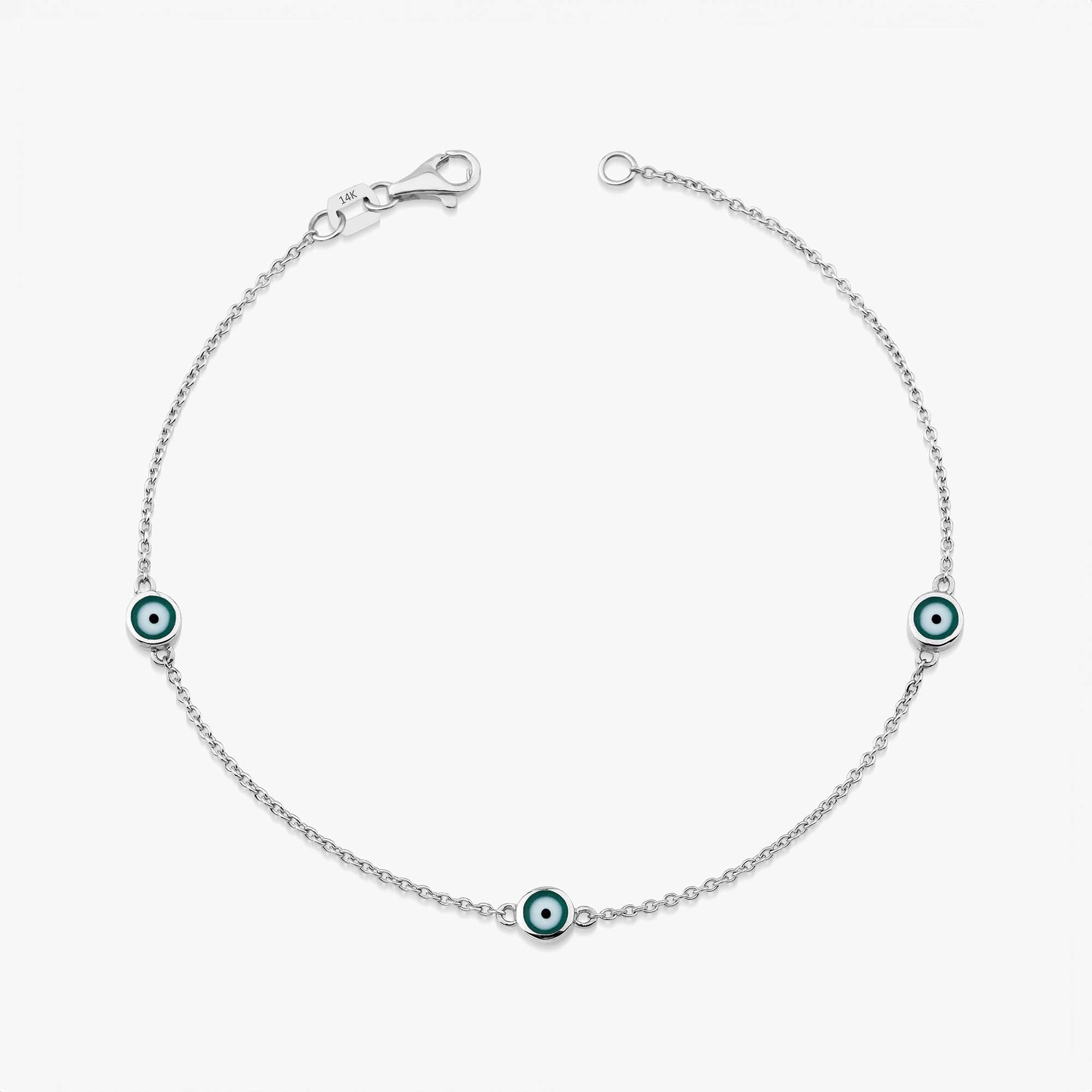 14 karat white gold three green evil eye bracelet with lobster clasp on a white background
