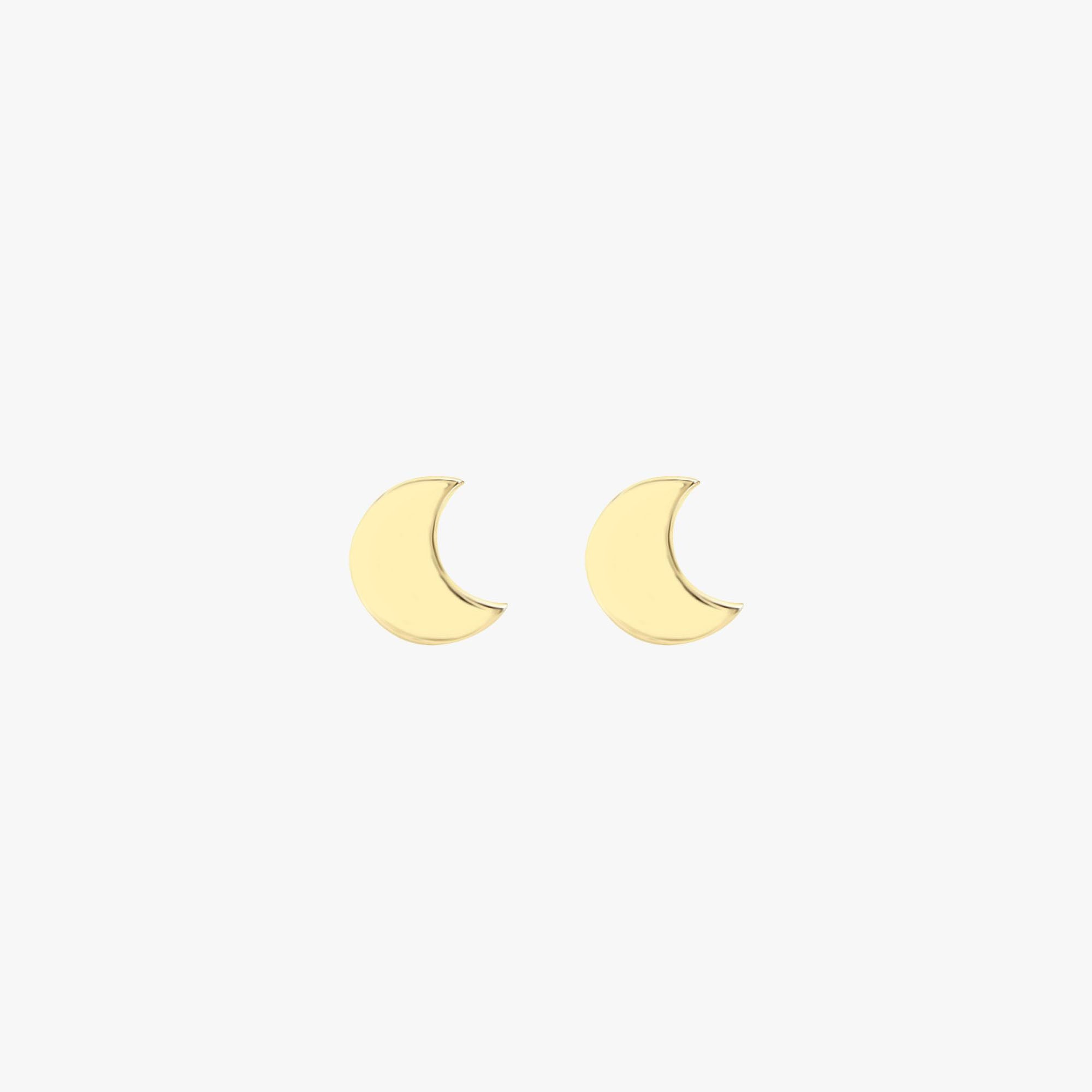 A pair of 14k yellow gold crescent moon studs on a white background