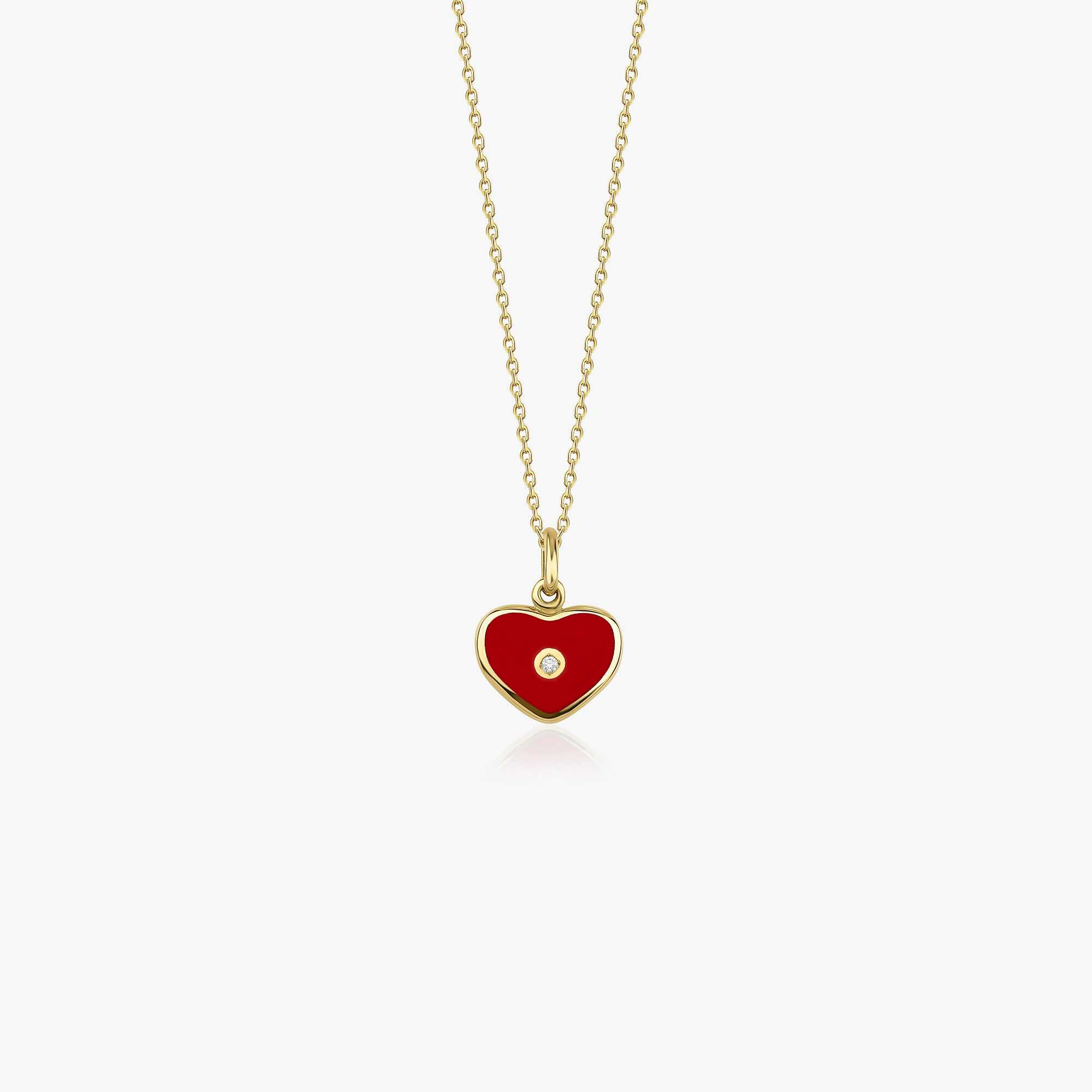 A 14K gold necklace with a red heart-shaped pendant inlaid with a diamond at its center, on a white background.