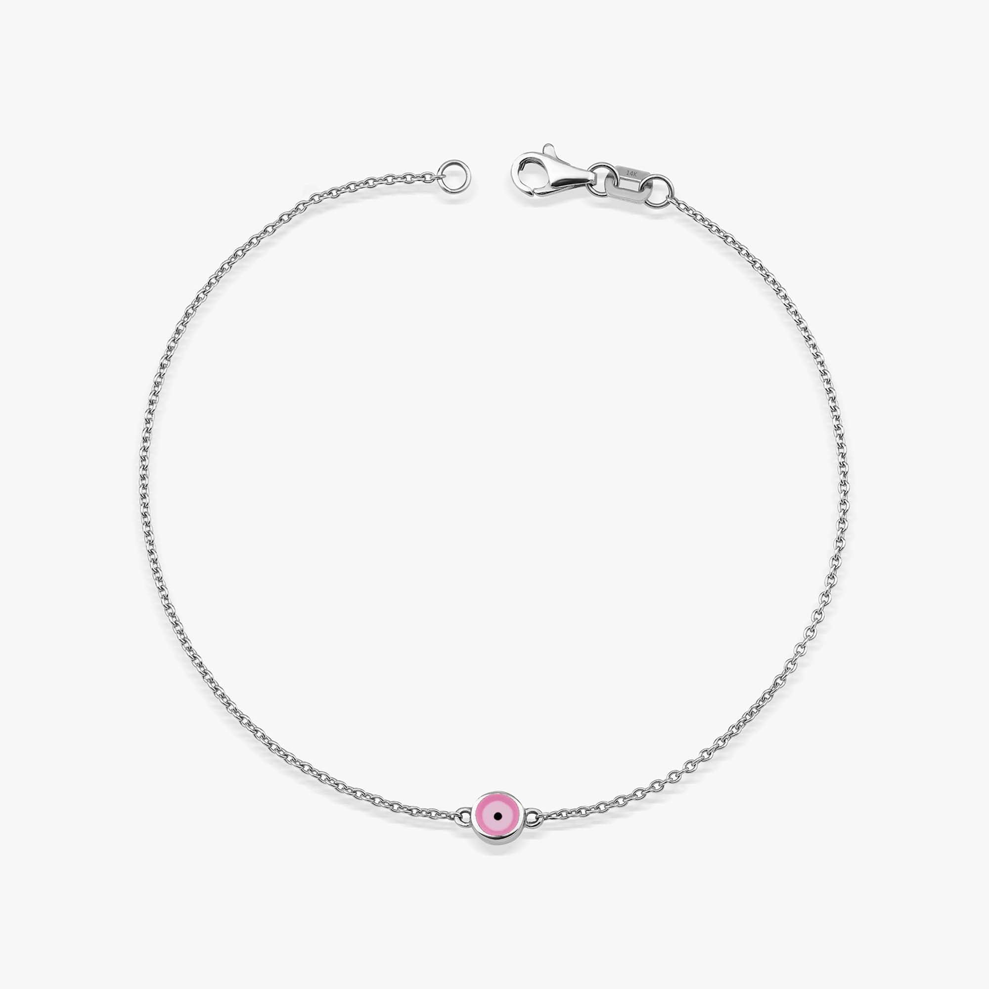 A 14K white gold bracelet with a double-sided pink enamel evil eye design, featuring a solid gold chain and a gold lobster clasp.