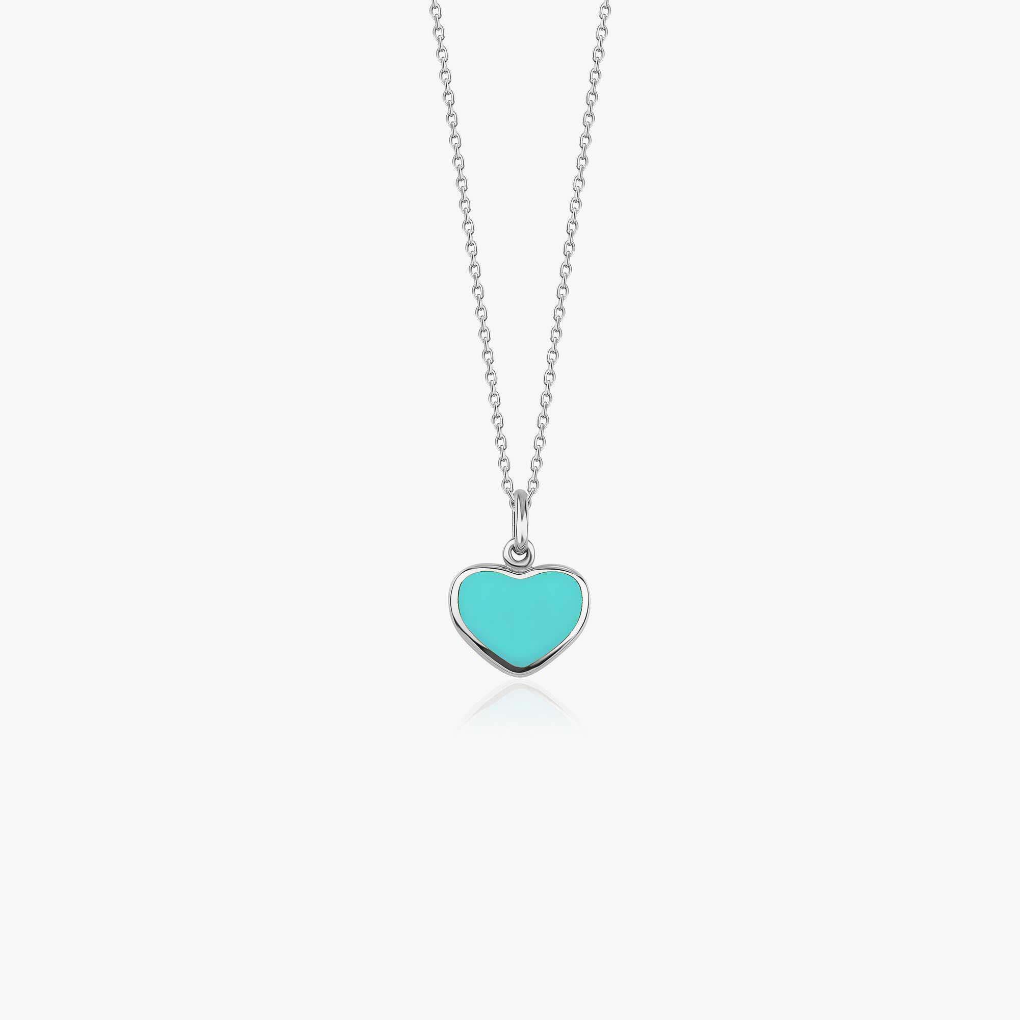 A 14k white gold heart pendant necklace with turquoise color enamel center shown on a white background