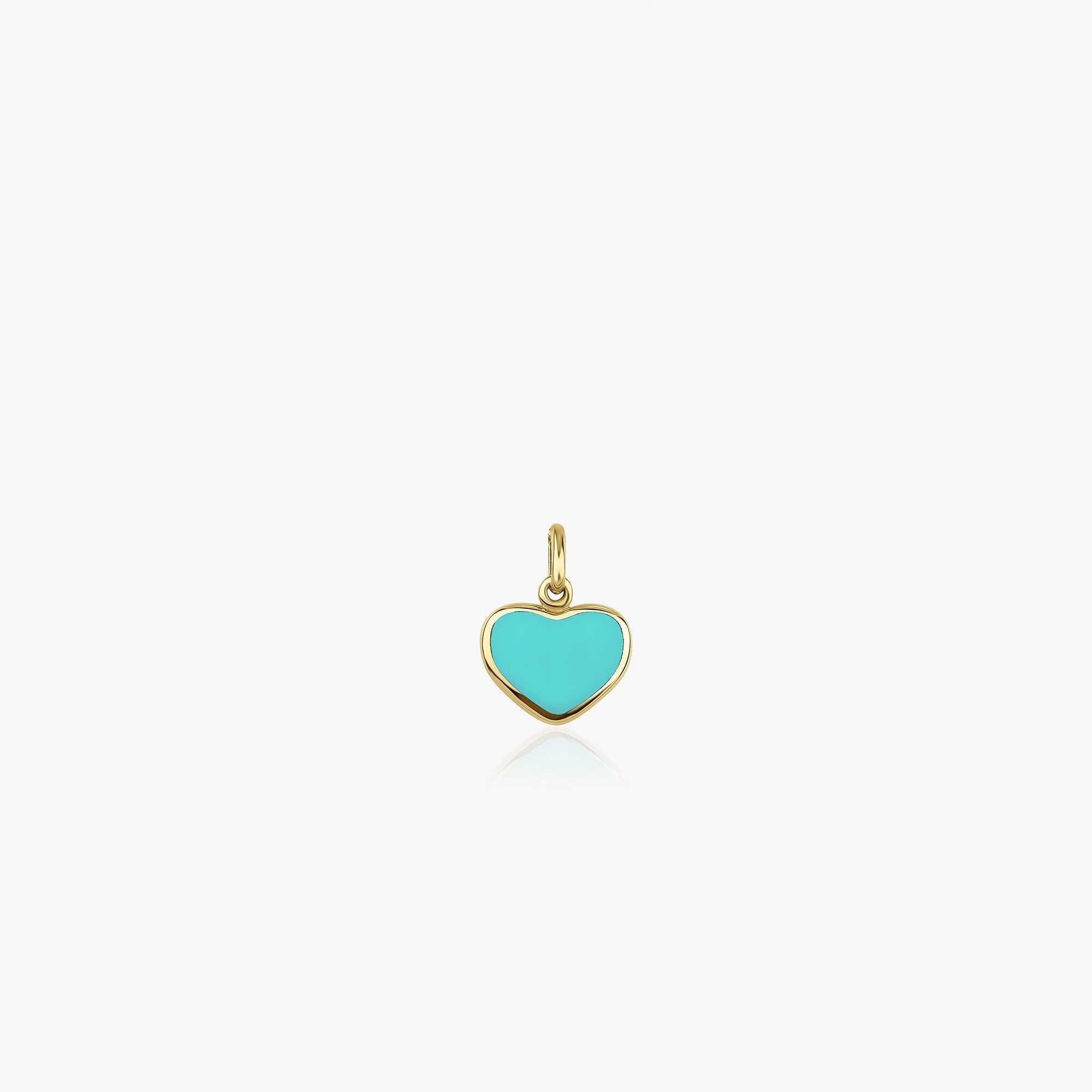 A small turquoise heart-shaped pendant made of 14K yellow gold, displayed against a white background.