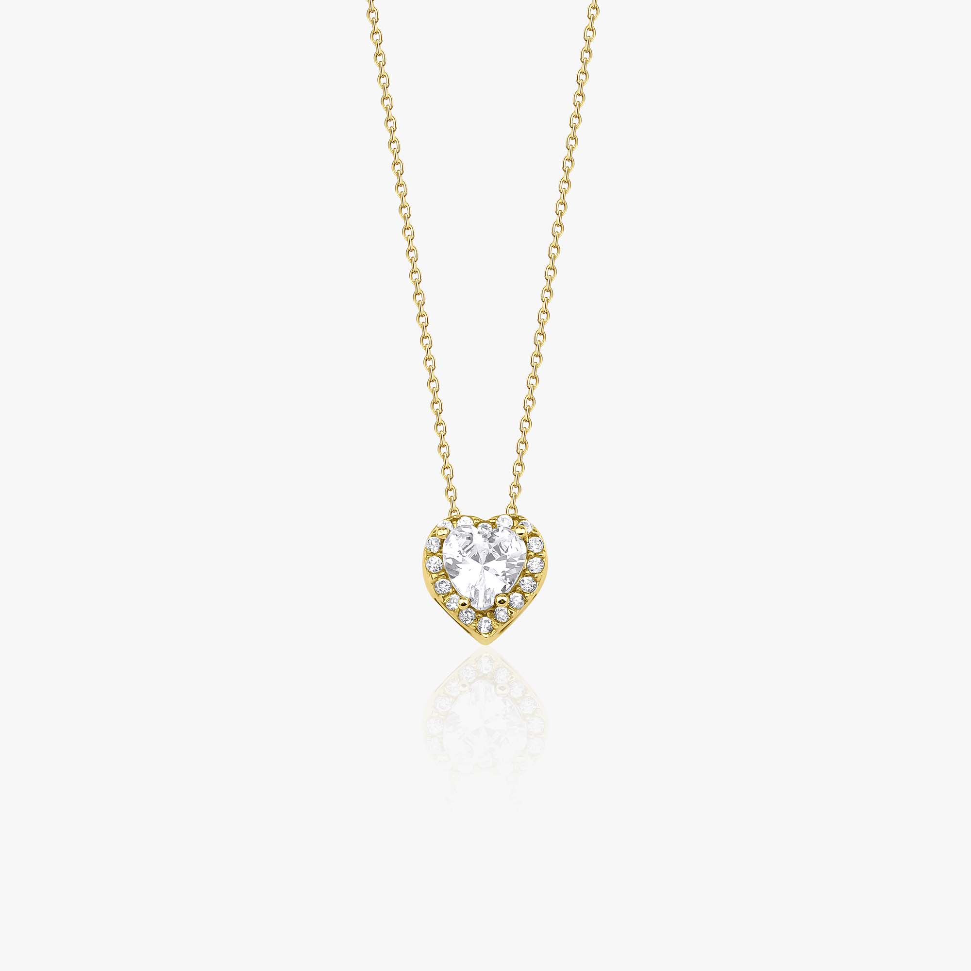 Heart-shaped cubic zirconia pendant on a gold chain against a white background