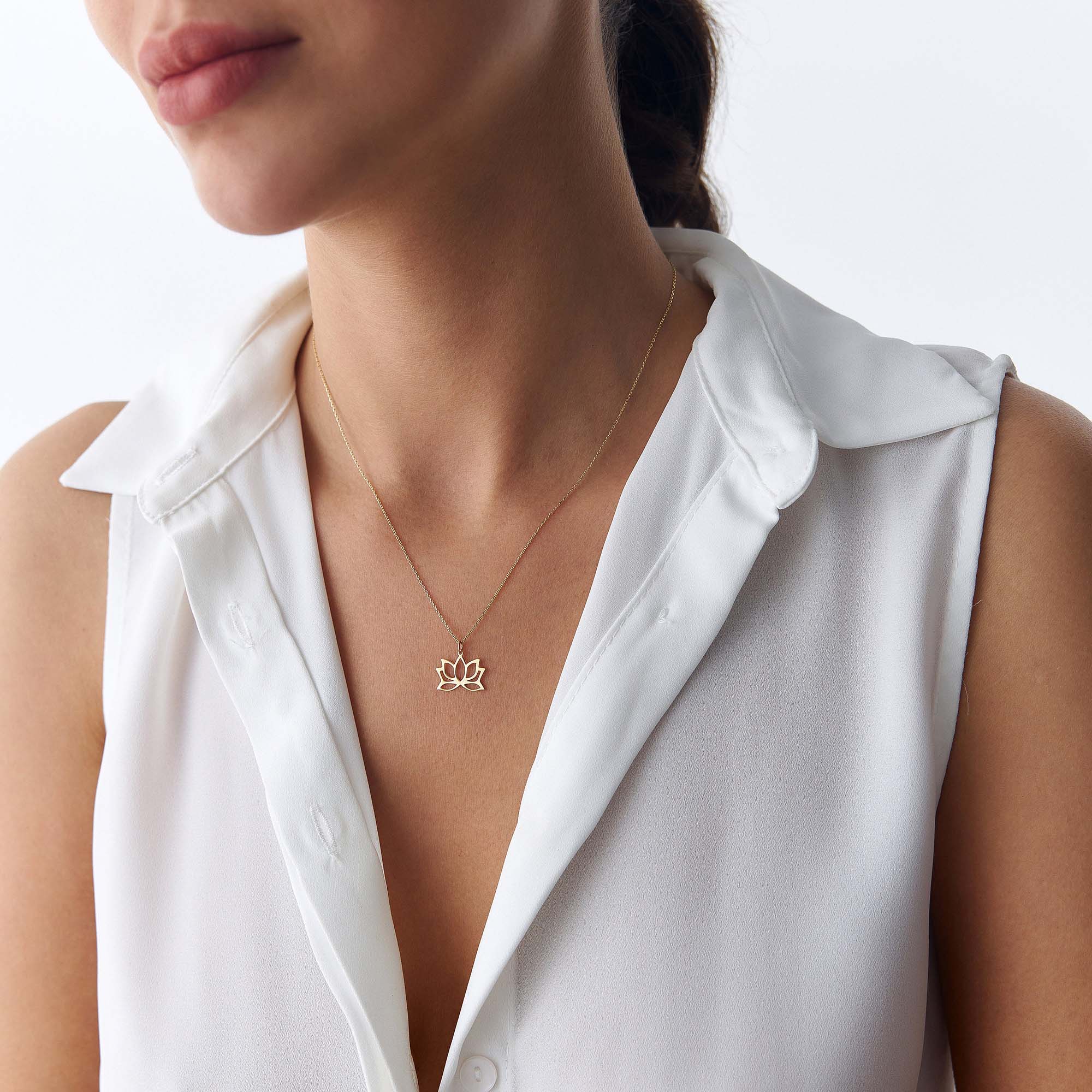 An image of a model wearing a minimal lotus pendant necklace.