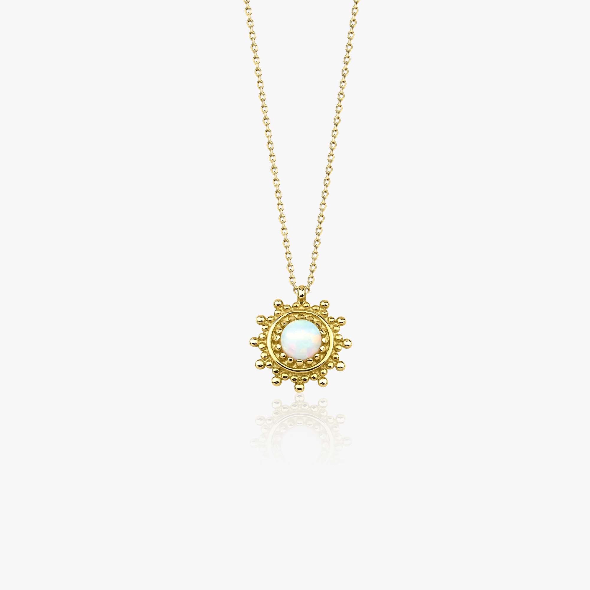 A 14k yellow gold minimal sun necklace with a lab opal center stone shown on a white background.