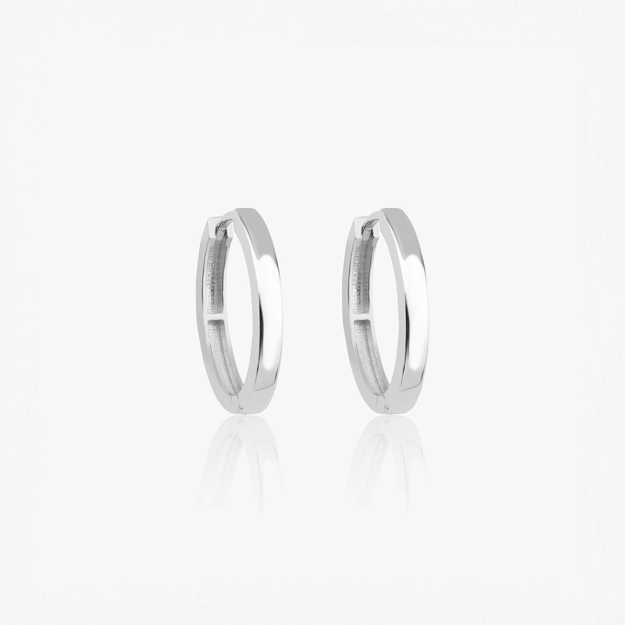 A pair of 14k white gold oval shaped hoops shown on a white background.