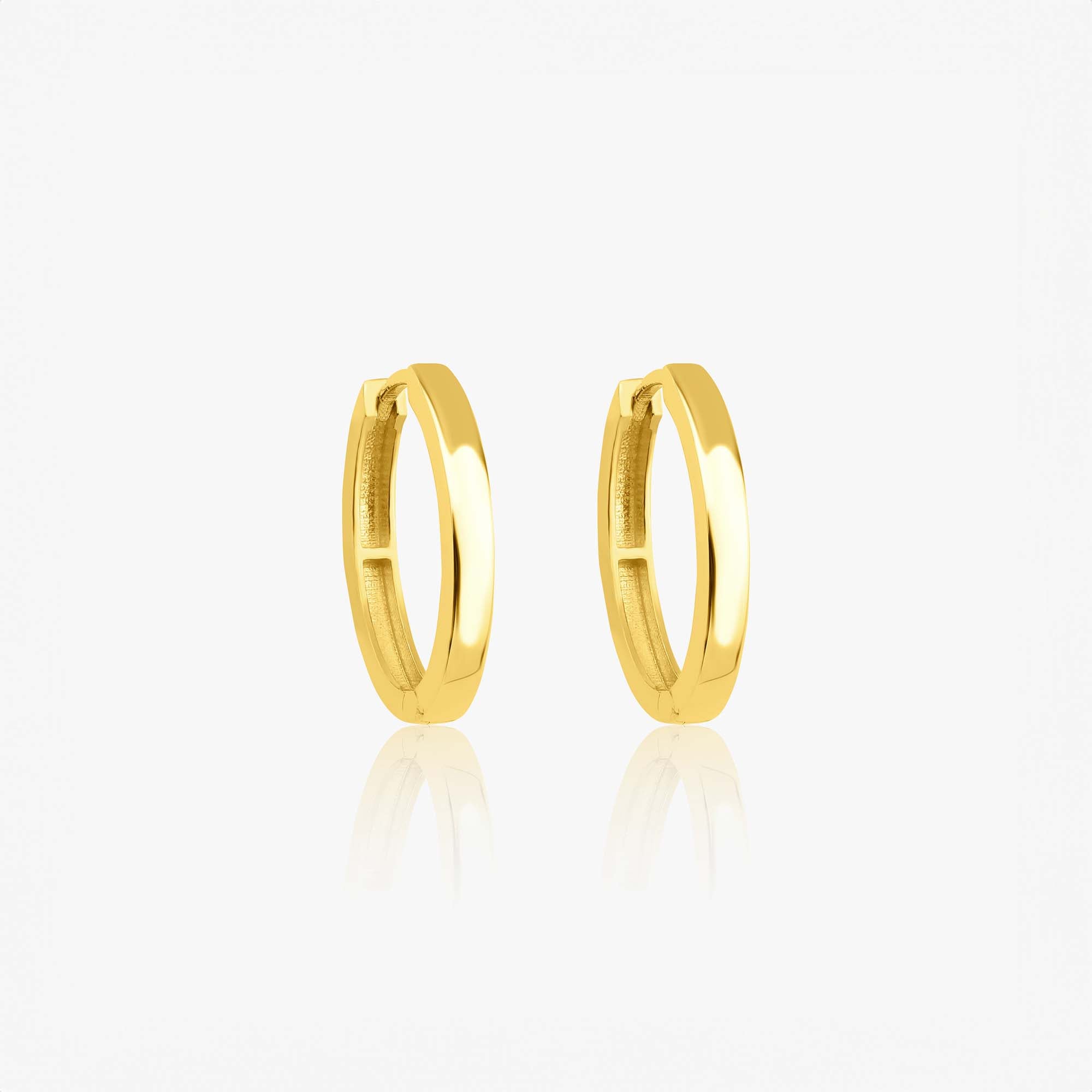A pair of 14k yellow gold oval shaped hoops shown on a white background.