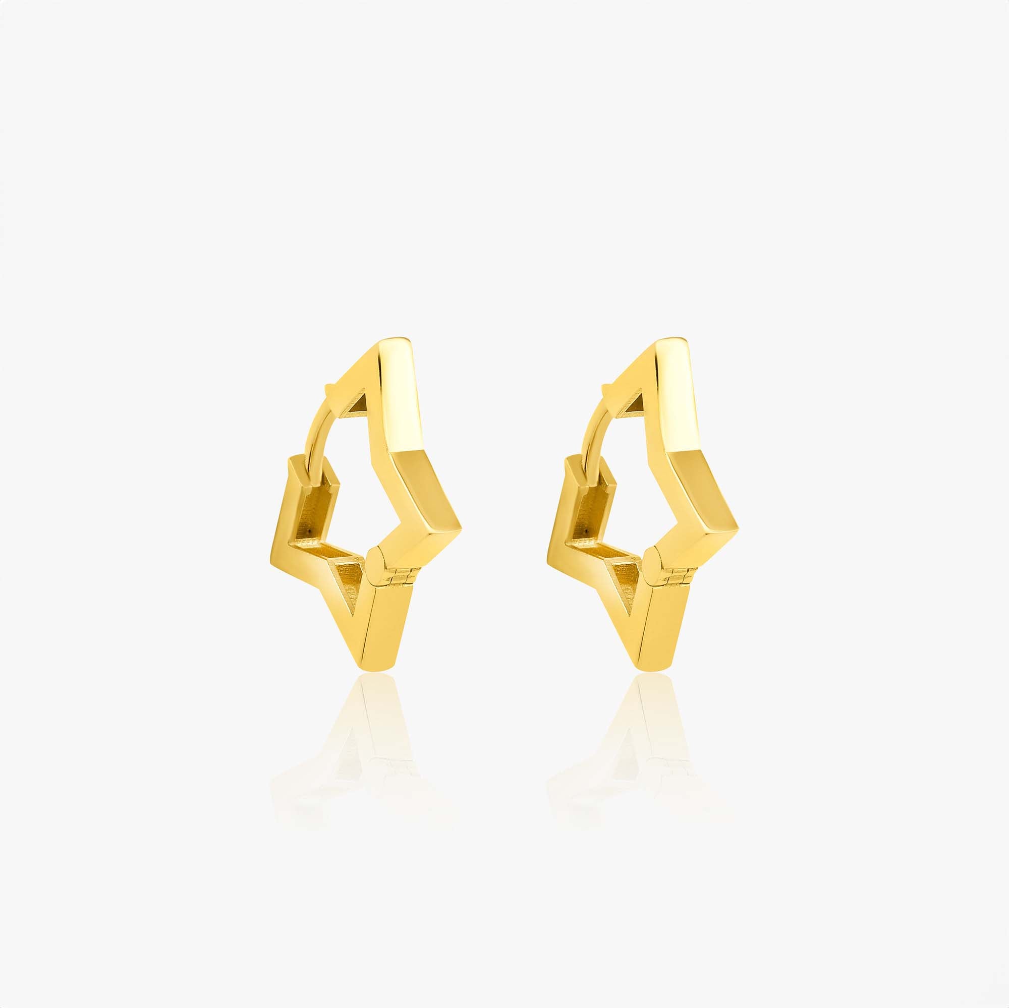 A pair of 14K gold star-shaped huggie hoop earrings on a white background.