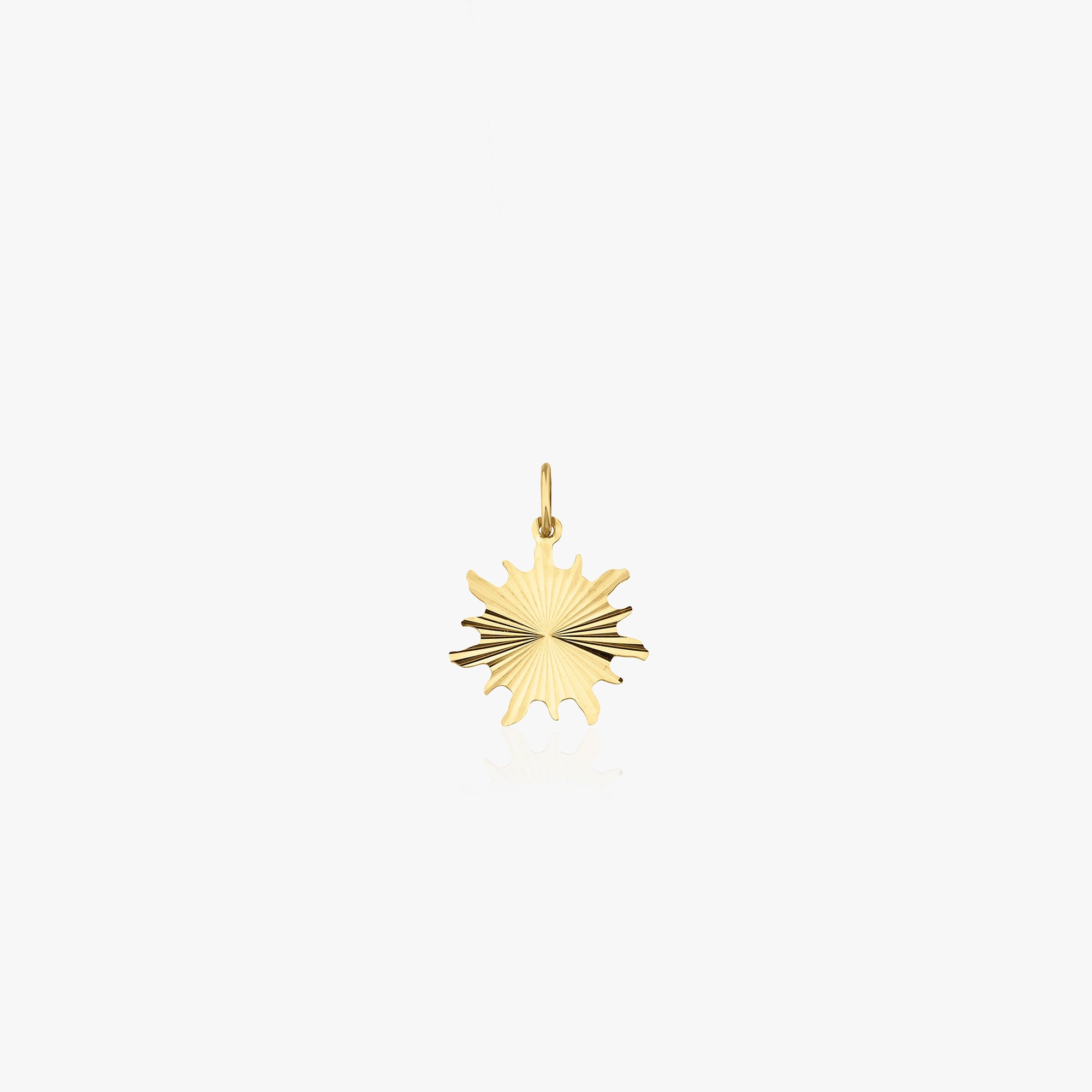 A 14k yellow gold glitter sun pendant shown on a white background