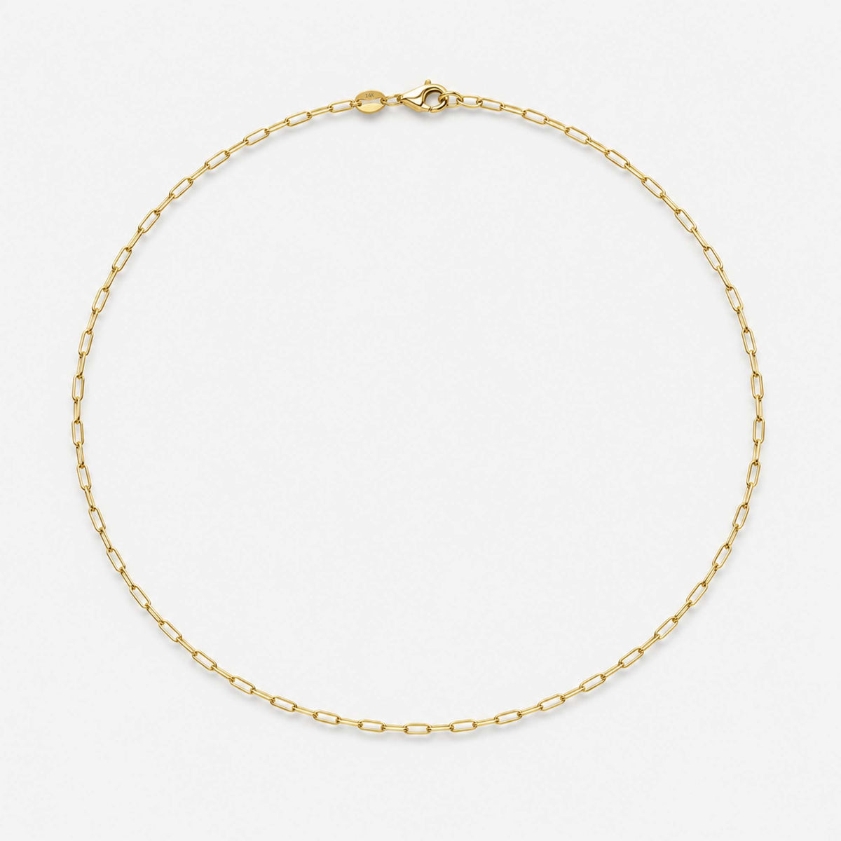A delicate 14K solid yellow gold paperclip chain necklace arranged in a circle on a clean white background.