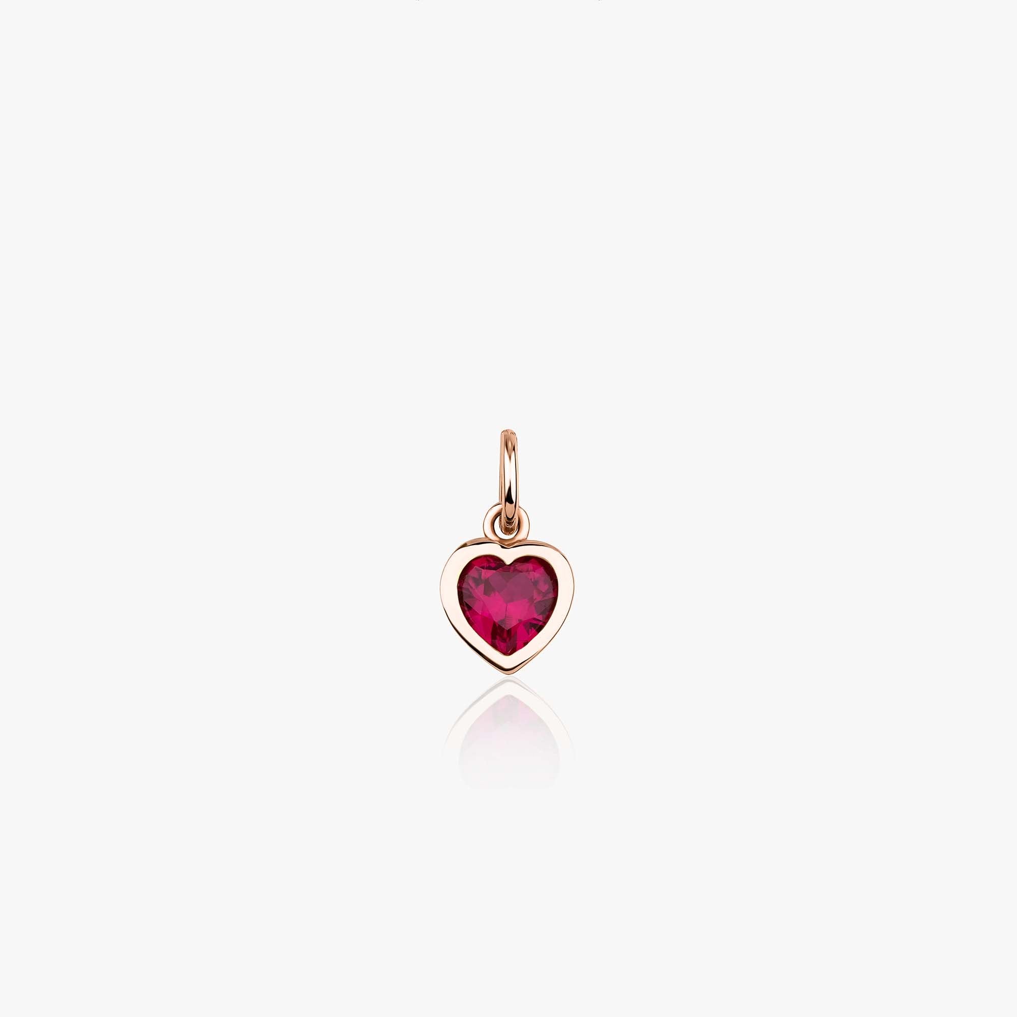 A 14K rose gold heart-shaped pendant with a red gemstone in the center, on a white background.