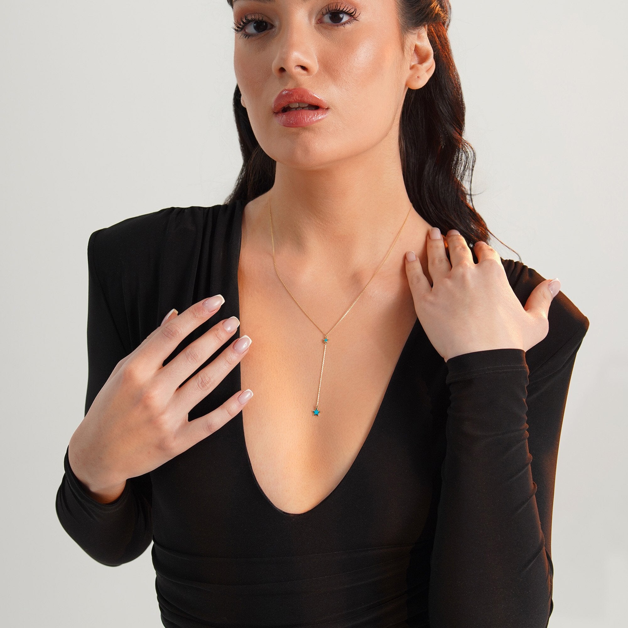 A model wearing a minimal star lariat necklace