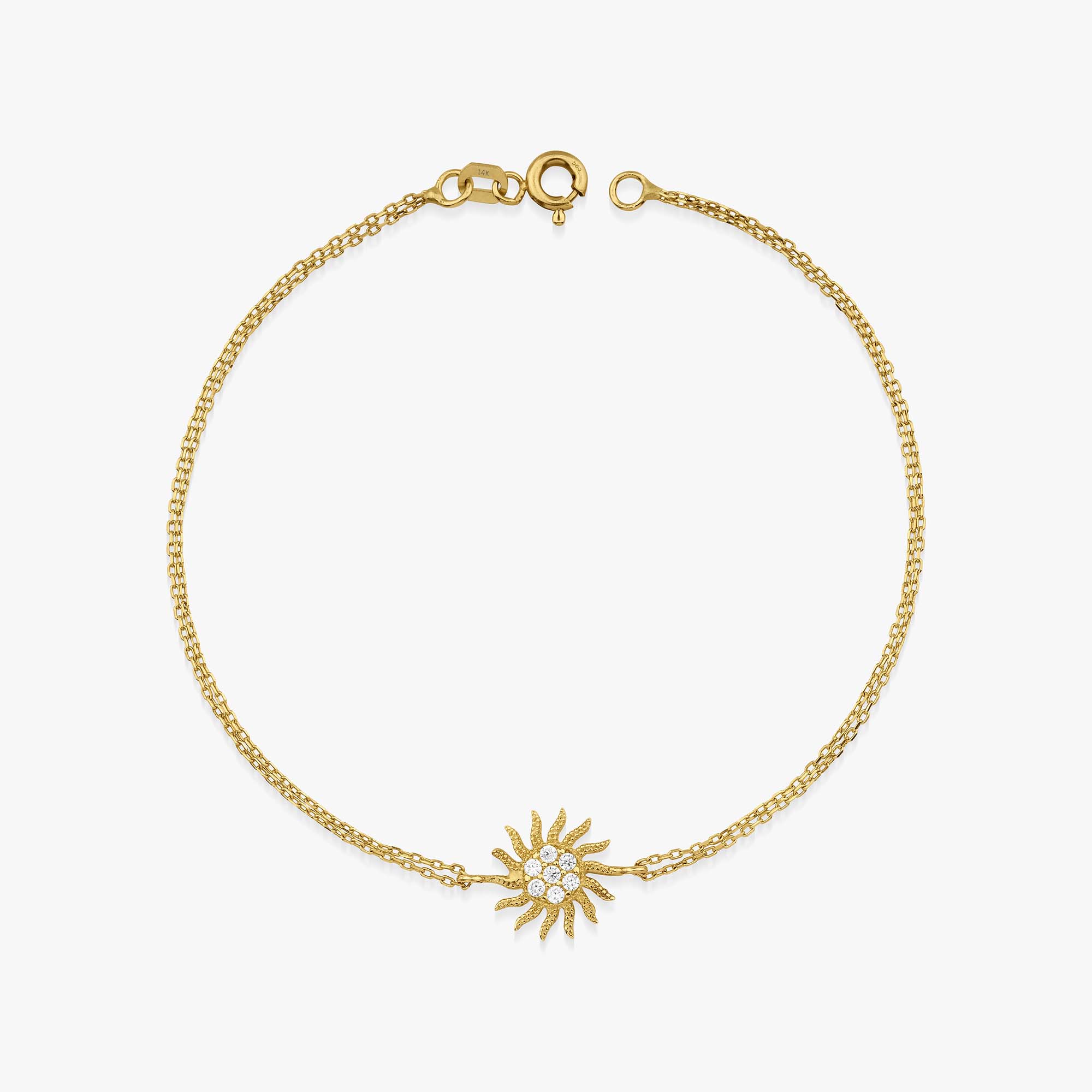 A 14K gold bracelet featuring a yellow gold chain with a sun charm adorned with cubic zirconia in the center.