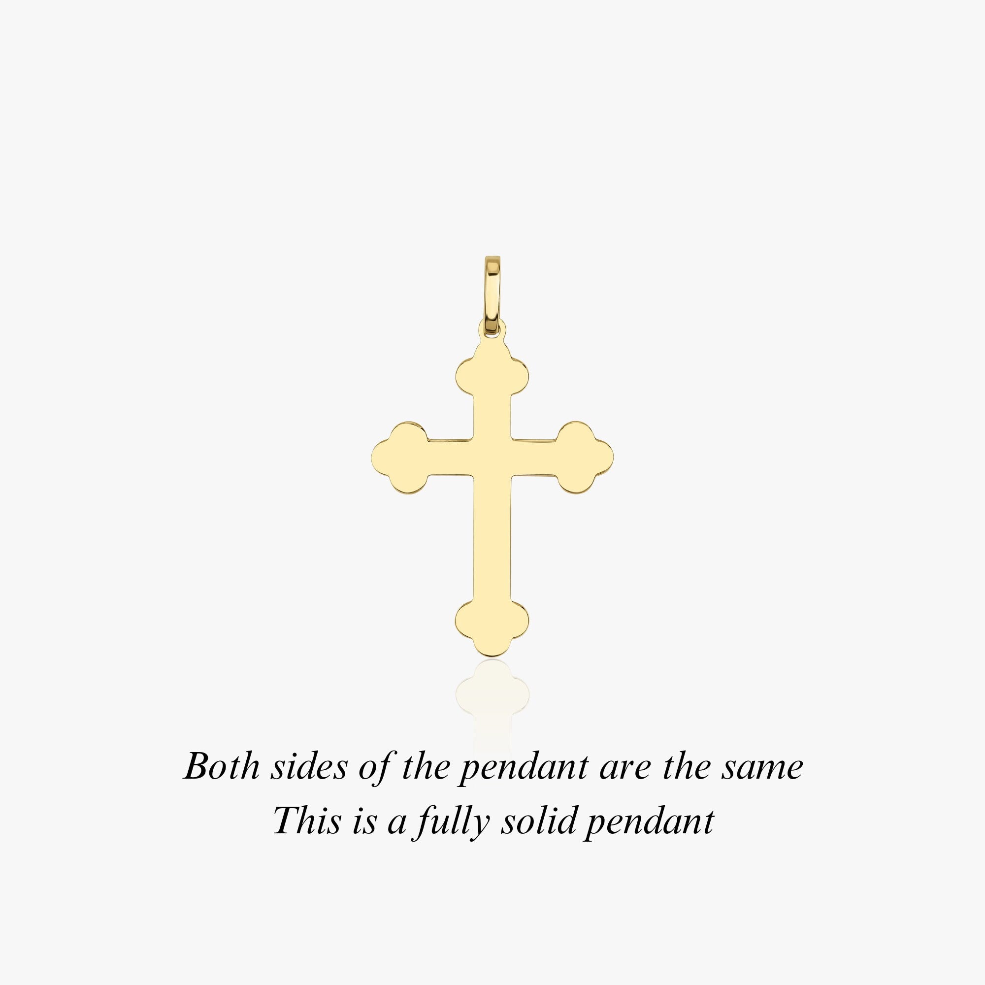 The backside of a large solid gold cross pendant displayed against a white background.